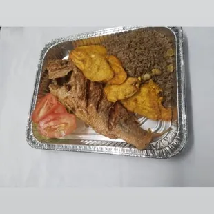 Red snapper Dinner served with house salad, fried plantains, and black mushroom rice.