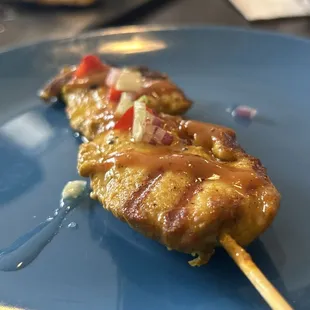 Chicken satay with peanut sauce and chopped vegetables in a sweet vinaigrette.