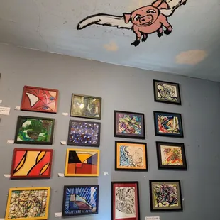 a variety of paintings on a wall