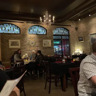 people sitting at tables in a restaurant