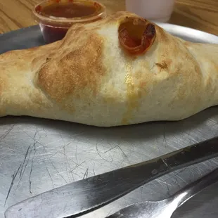 A pepperoni calzone with ricotta and mozzarella cheese fresh out of the oven.