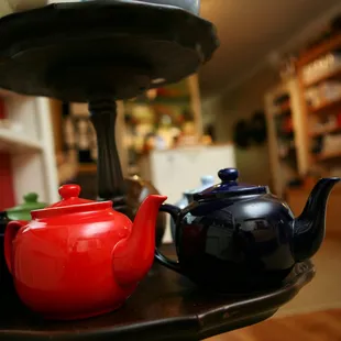 a red teapot and a blue teapot