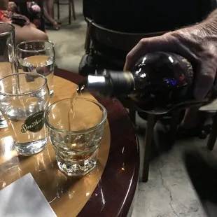 a man pouring a glass of wine