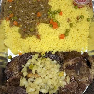 a tray of food with meat, rice and vegetables