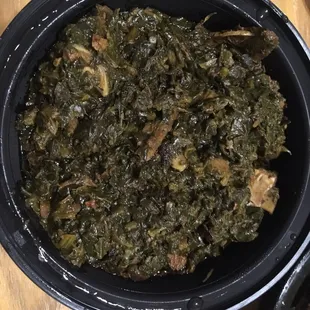 a bowl of greens and meat