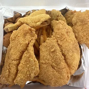 catfish, oysters and shrimp with french fries and hush puppies