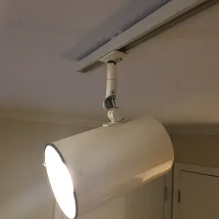 Broken lights carelessly hanging from a wire in the ceiling. Fire Hazzard.