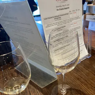 a glass of wine and a menu