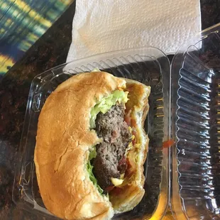 a hamburger in a plastic container