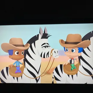 two zebras and a cowboy