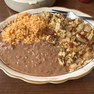 Breakfast eggs, onions, &amp; potatoes, Mexican rice, &amp; seasoned beans with hot corn tortillas and a cup of hot coffee