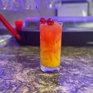 a cocktail with a cherry garnish