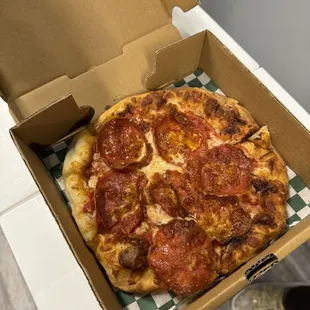 a pepperoni pizza in a box