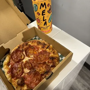 a box of pizza and a can of soda