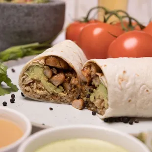 a burrito cut in half on a plate