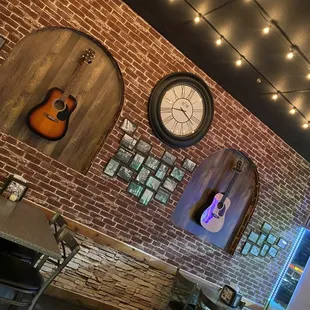 a brick wall with guitars on it
