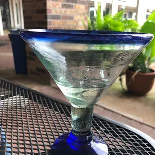 Empty margarita glass on patio table