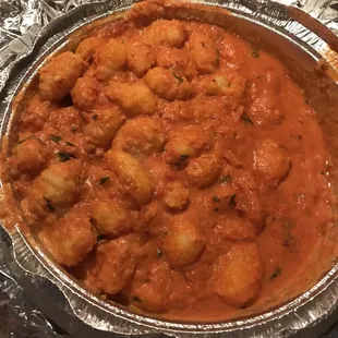 a pan of chicken in a tomato sauce