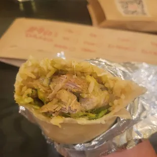 a hand holding a burrito