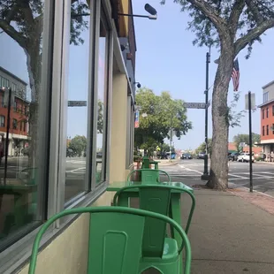green chairs on the sidewalk