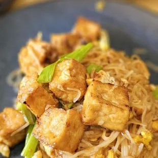 a plate of noodles with tofu