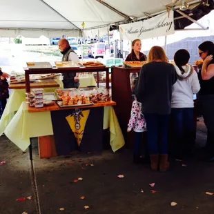 a group of people standing under a tent