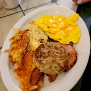Hash browns, scrambled eggs and meat.
