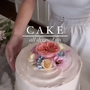 a woman decorating a cake