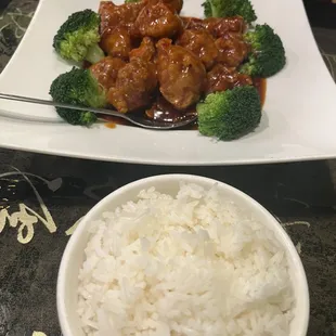 a plate of chicken and broccoli with rice