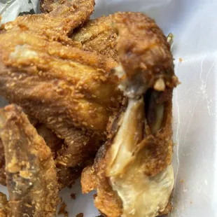 Old over fried and very nasty chicken ( think they were trying to make a new form of chicken jerky on the bone.