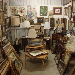 A seller in the back corner with an impressive amount of vintage &amp; antique frames, photos, and prints.