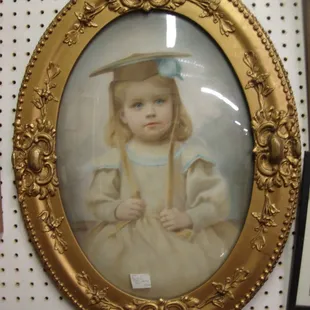 A striking turn of the century colorized photo in an oval bubble glass frame.