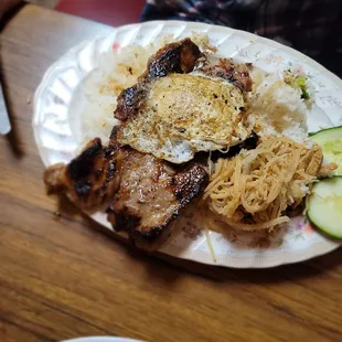 Com w pork chop and pork skin shreds.