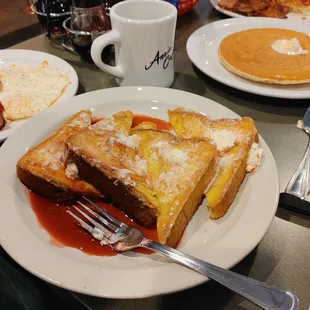 Nice size French toast with egg bread. Moist center with warm butter and raspberry syrup.