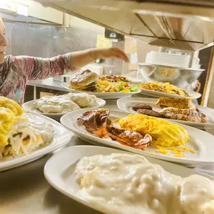 a child reaching for a plate of food