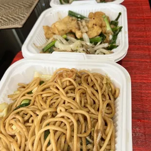 three takeout containers of noodles