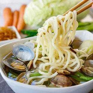 a bowl of noodles and clams