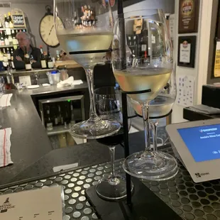 two glasses of wine on a bar