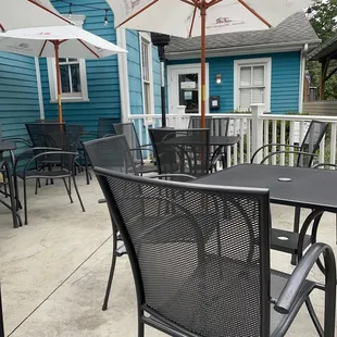 a patio with tables and umbrellas