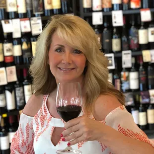 a woman holding a glass of wine