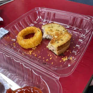 a sandwich and donut in a plastic container