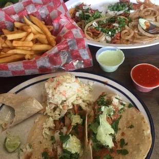 a plate of tacos and french fries