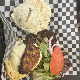 Island burger with potato salad.