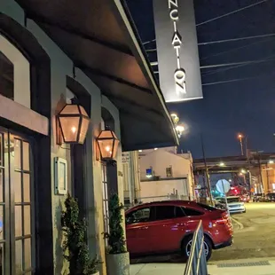 a red car parked in front of a restaurant