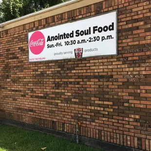 a sign on a brick wall