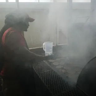 Owner Chad Pradia grilling burgers