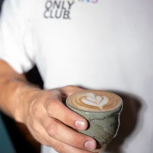 a man holding a cup of coffee