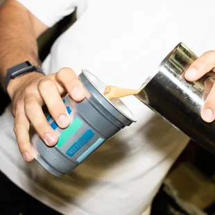 a man pouring a cup of coffee