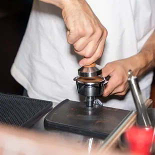 a man making a cup of coffee