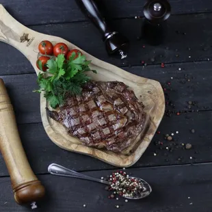 a steak on a wooden cutting board